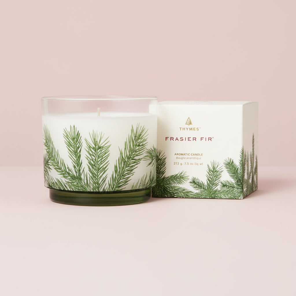 Fragranced candle with green leaf design and packaging on a white background