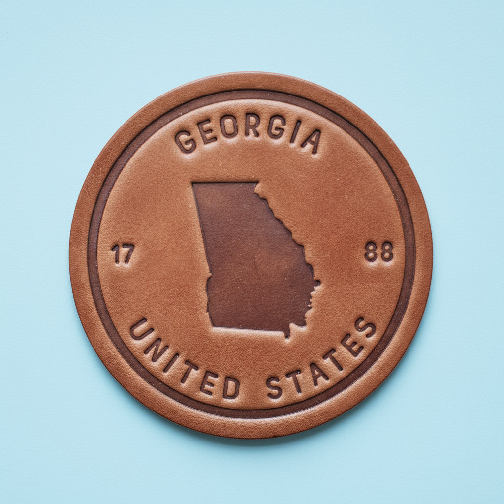 Bronze-colored emblem with 'Georgia' and 'United States' text on a wooden background