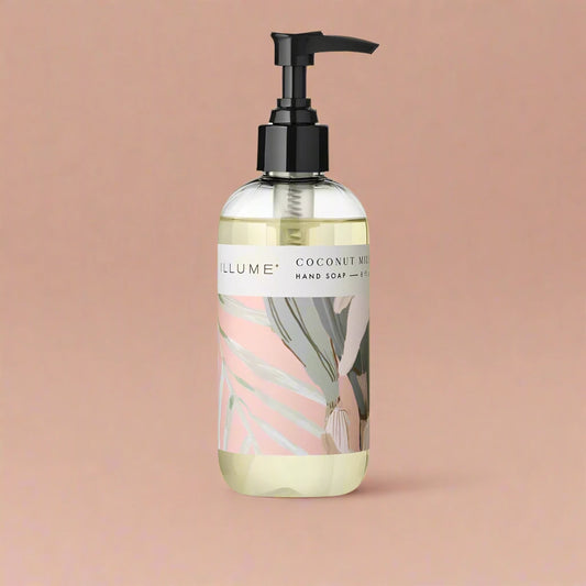 Hand soap bottle with coconut milk and mango scent, styled for a tropical, refreshing look.