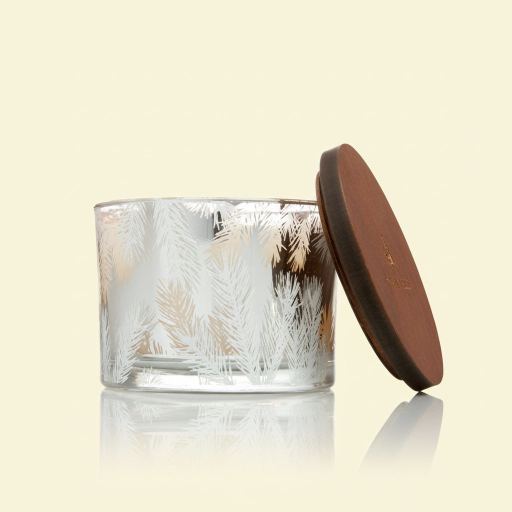 Glass candle with a textured design and a brown lid on a white background