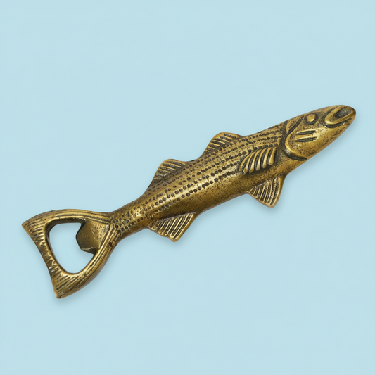 Bronze fish-shaped bottle opener on a white background