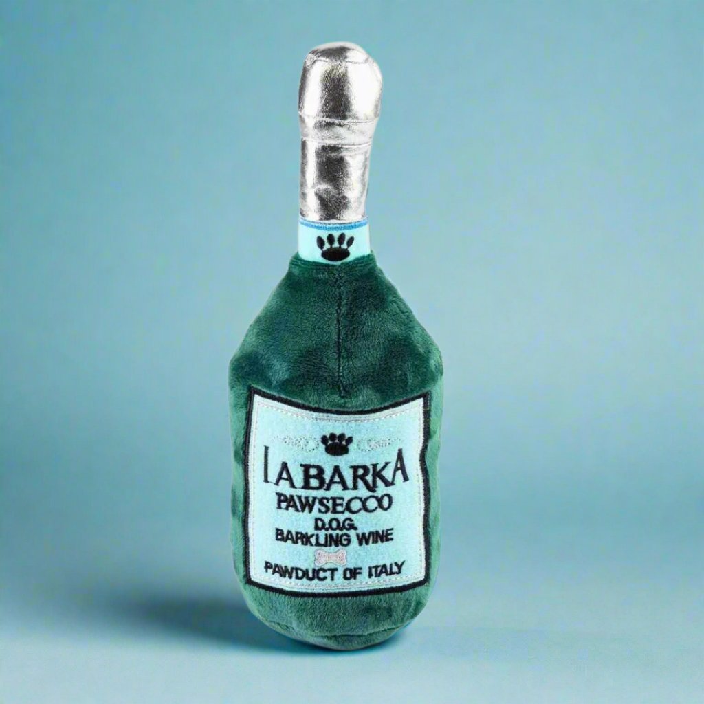 Plush_dog_toy_shaped_like_a_prosecco_bottle_featuring_a_soft_exterior_and_hidden_squeaker_perfect_for_playful_pups_looking_to_add_a_touch_of_fun_and_class_to_their_toy_collection.