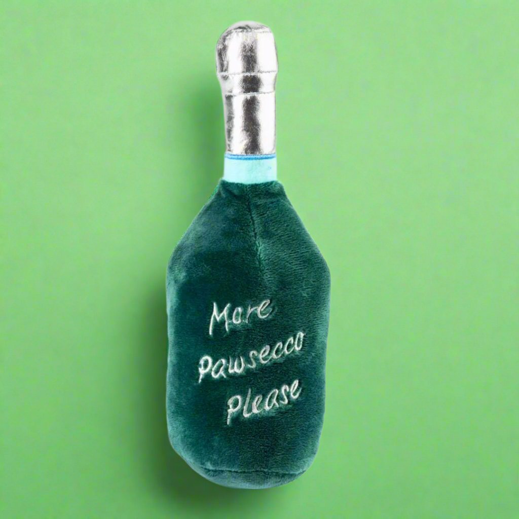 Plush_dog_toy_shaped_like_a_prosecco_bottle_featuring_a_soft_exterior_and_hidden_squeaker_perfect_for_playful_pups_looking_to_add_a_touch_of_fun_and_class_to_their_toy_collection.copy