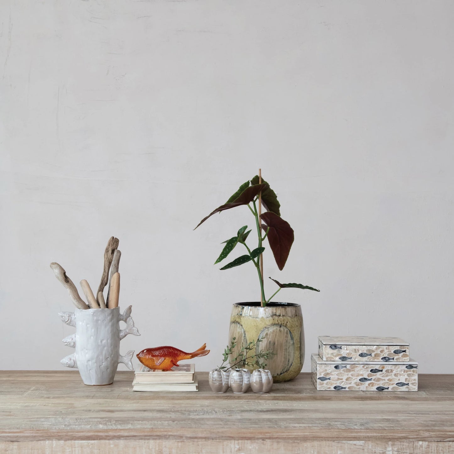 Decorative items on a wooden surface with a plain background