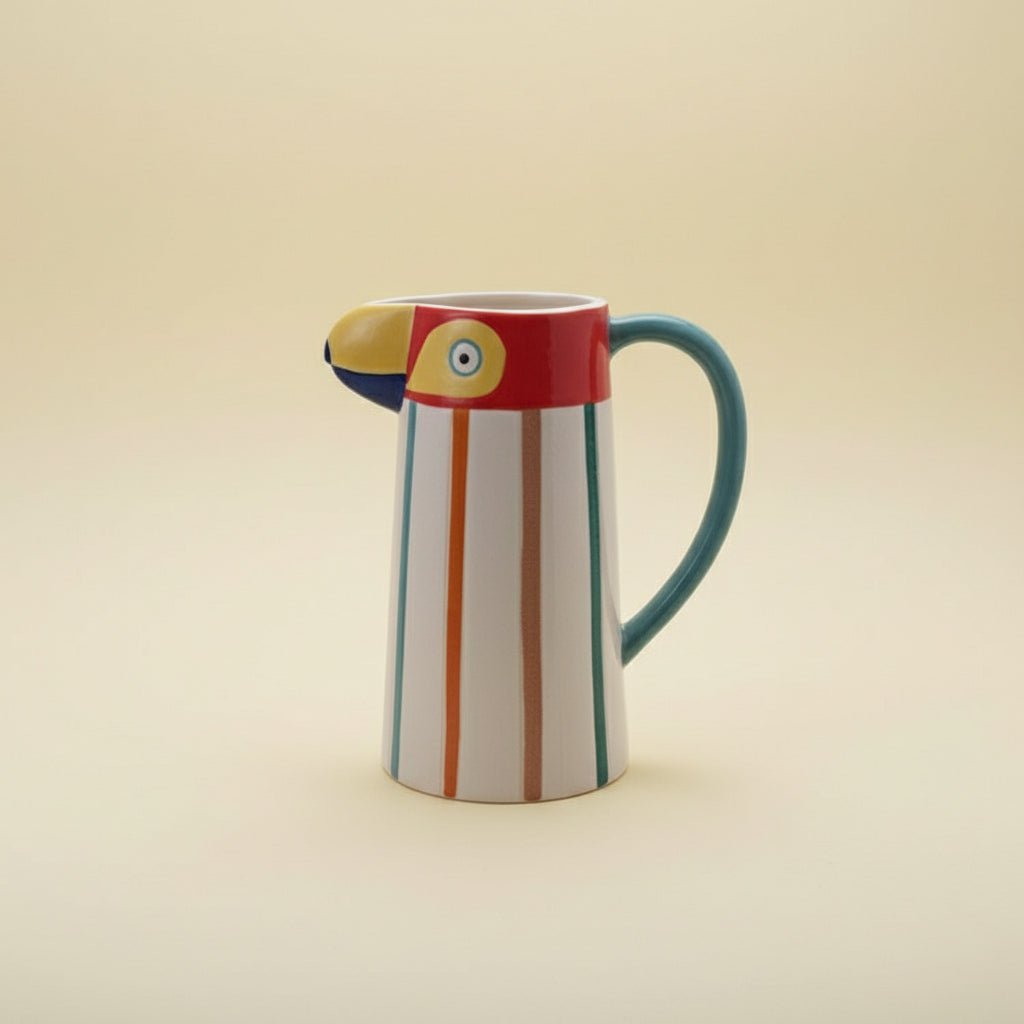 Colorful ceramic pitcher with striped design on a white background