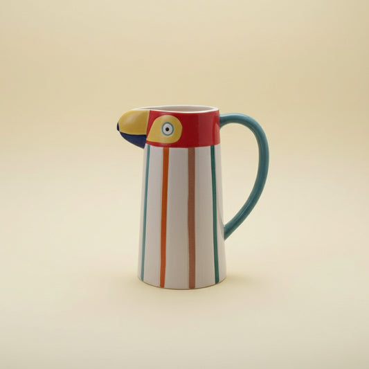 Colorful ceramic pitcher with striped design on a white background