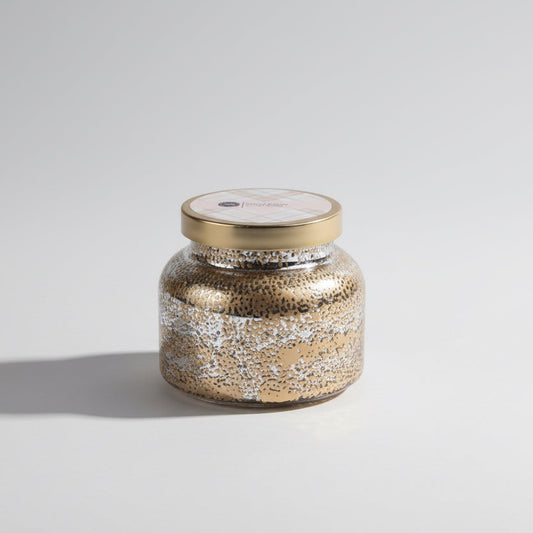 Decorative jar with gold lid on a white background