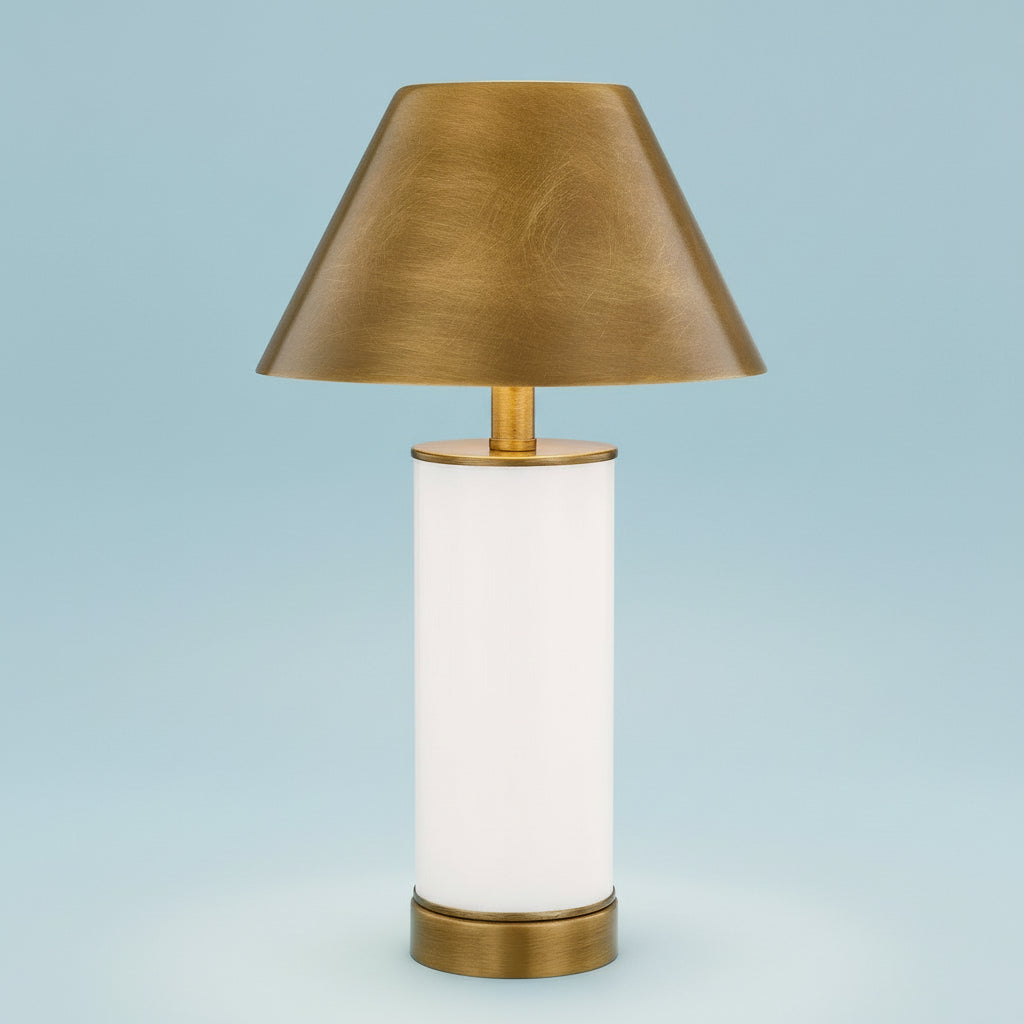 Table lamp with brass shade and base on a white background