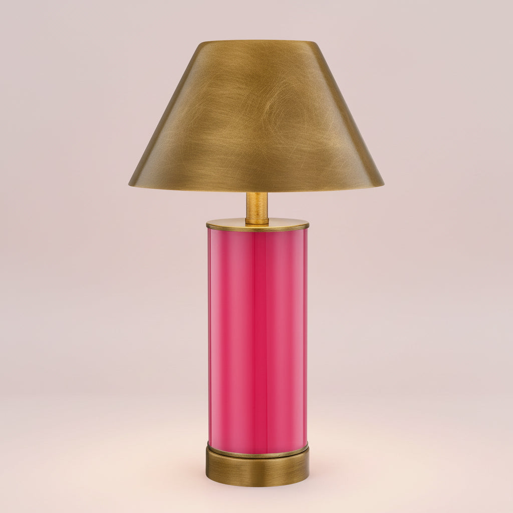 Table lamp with a pink base and gold shade on a white background