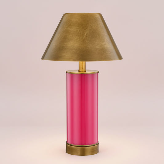 Table lamp with a pink base and gold shade on a white background