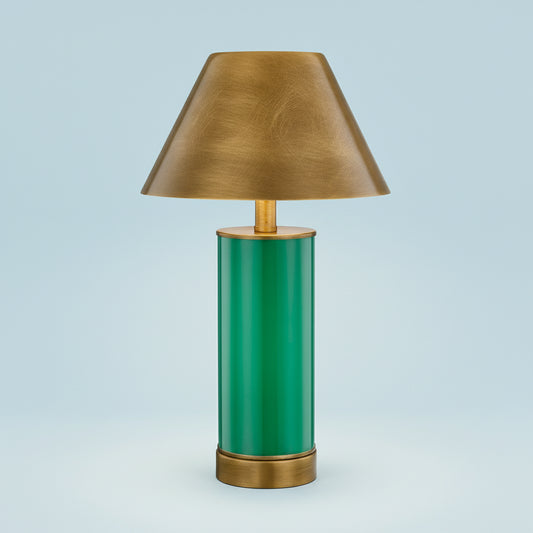 Table lamp with green base and gold shade on a white background