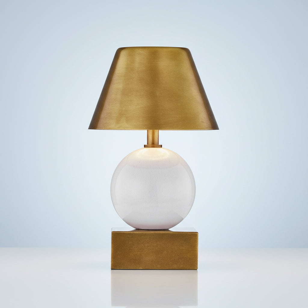 Table lamp with gold shade and base on a white background