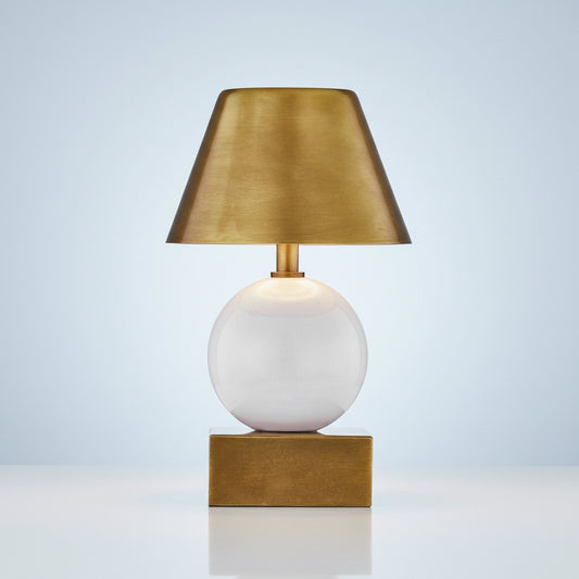 Table lamp with gold shade and base on a white background