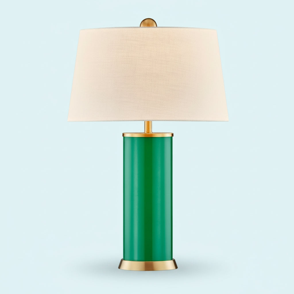 Table lamp with green base, gold accents, and beige lampshade on a white background