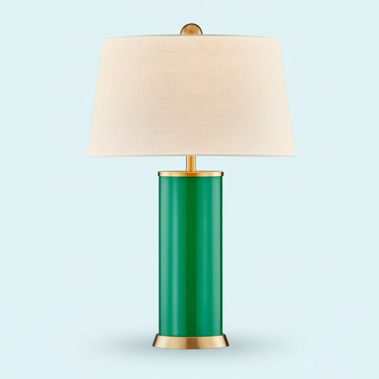 Table lamp with green base, gold accents, and beige lampshade on a white background