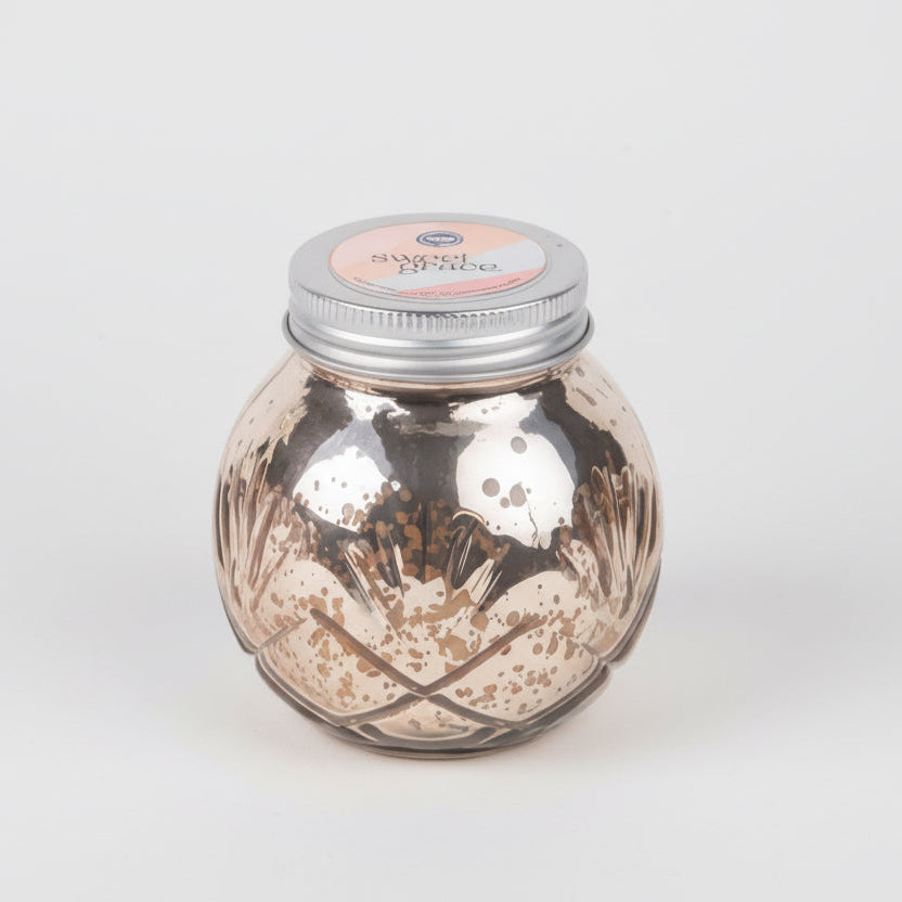 Decorative glass jar with metallic finish and silver lid on a white background