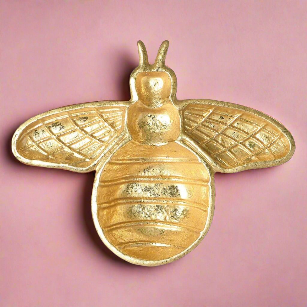 A golden bee-shaped dish, ideal for holding jewelry, soaps, or trinkets, adding a whimsical touch to a bathroom or kitchen counter.