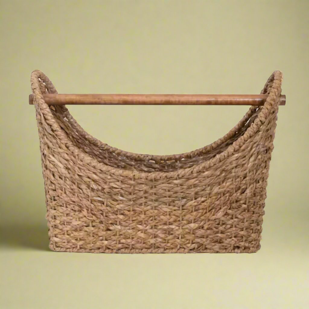 An oval-shaped rattan woven basket with handles, ideal for storage or decor, adding a rustic, natural touch to any room.