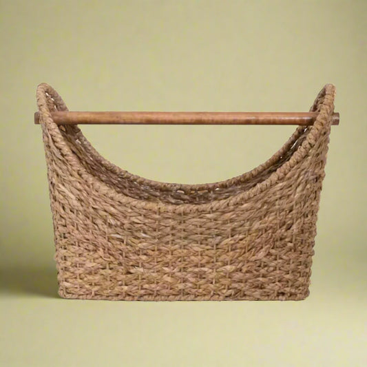 An oval-shaped rattan woven basket with handles, ideal for storage or decor, adding a rustic, natural touch to any room.