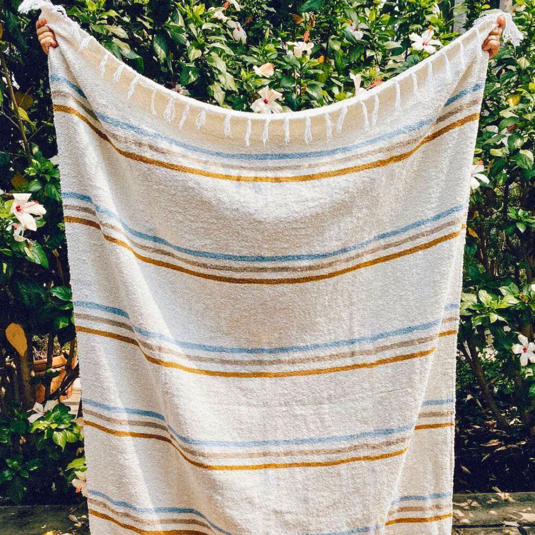 Coastal-themed_throw_blanket_made_from_sustainable_recycled_materials_perfect_for_adding_warmth_and_eco-friendly_style_to_any_living_space.copy