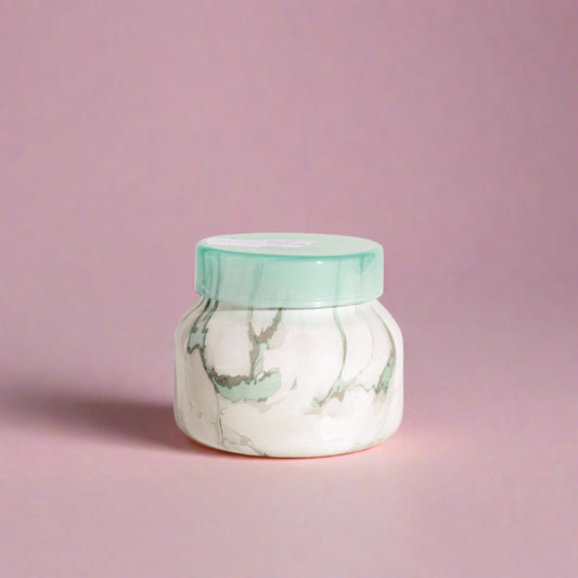 Coconut-scented candle in a coastal-themed container, ideal for adding a beachy, relaxing ambiance to any living space.