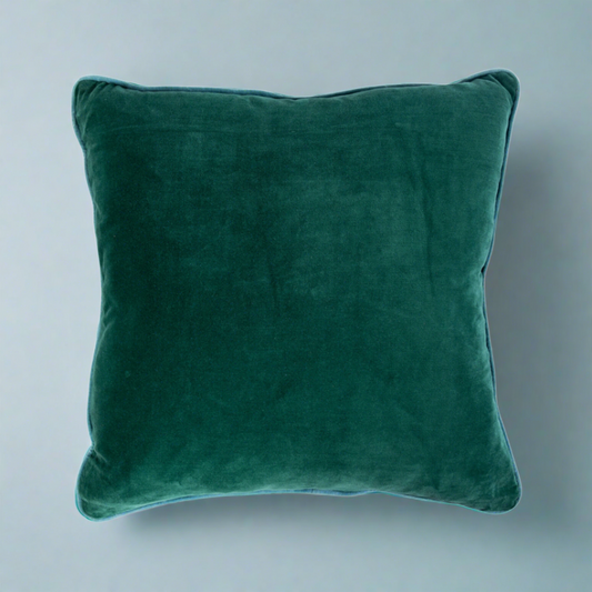 Emerald green velvet pillow with a plush, luxurious feel, ideal for adding a bold and elegant touch to sofas, chairs, or beds in any living space.