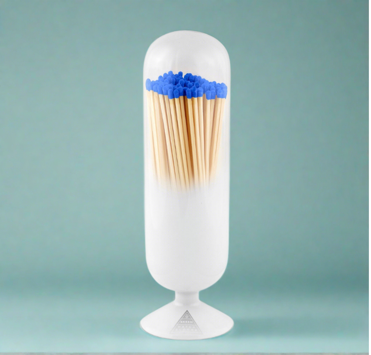 Hand-blown Aegean Blue-Tipped Match Cloche with a serene ombré effect, filled with blue-tipped matches and topped with a cork stopper, blending coastal elegance and practical charm.
