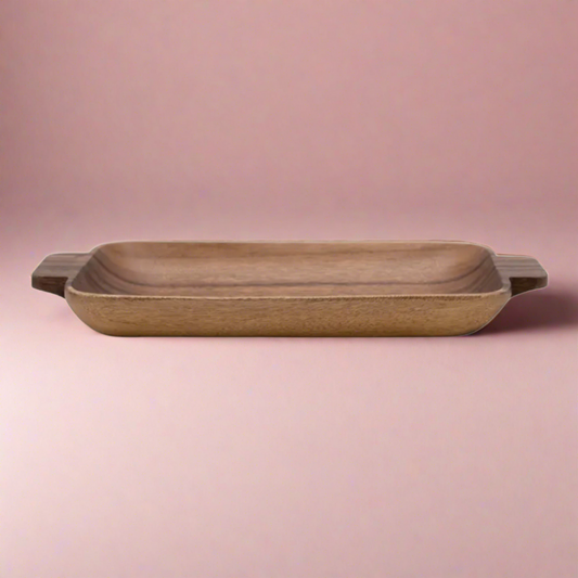 Hand-carved Acacia wood tray with convenient handles, measuring 17.5"L x 7.5"W x 2"H, perfect for serving, hosting, or as a decorative piece, adding natural elegance to any setting.