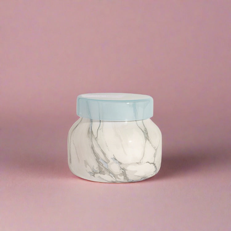 Petite jar candle with an eye-catching design and a soothing Blue Jean fragrance, perfect for adding a tranquil aroma and stylish touch to any room.