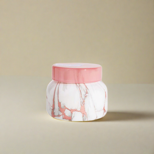 Pink scented candle in a stylish container, perfect for adding a touch of Parisian elegance and a soft, inviting glow to any room.







