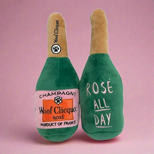 Plush dog toy designed like a wine bottle with "Rosé All Day" on it, featuring a soft exterior and hidden squeaker, ideal for playful pups who love a touch of luxury during playtime.