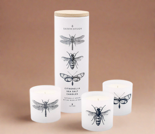 Set of three Sea Breeze Citronella Candles, each in a sleek container, infused with ocean air, citronella, sea salt, and jasmine, designed to repel insects and create a tranquil outdoor ambiance.