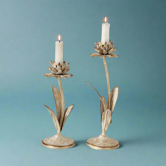 Set of two distressed white and gold flower-shaped metal candle holders for taper candles
