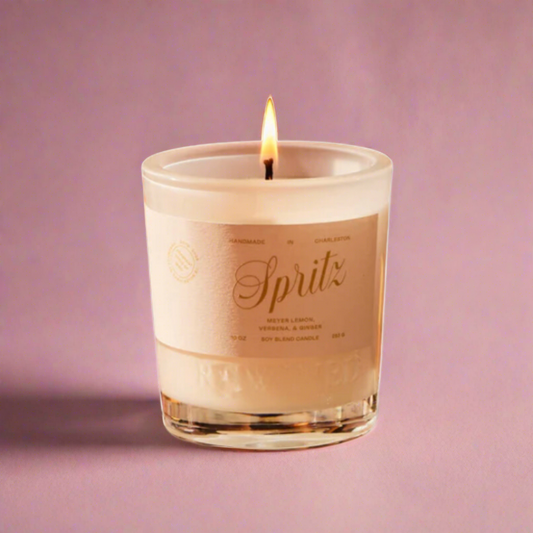 Spritz Candle with zesty citrus, sparkling fizz, and bitter orange scents. Evokes a sun-drenched Mediterranean terrace with each flicker.
