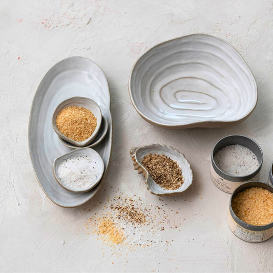 Stoneware_bowl_with_a_shell-inspired_design_perfect_for_serving_snacks_or_as_a_decorative_piece_adding_a_unique_coastal_charm_to_any_table_setting.copy