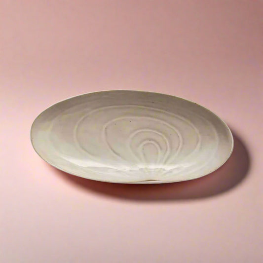 Stoneware_plate_with_a_shell_design_perfect_for_adding_a_coastal_beach-inspired_touch_to_your_dining_experience_ideal_for_serving_appetizers_salads_or_as_a_decorative_piece.
