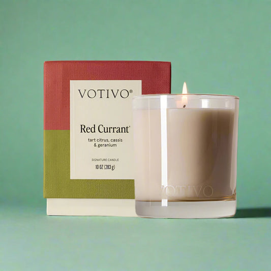 10 oz. minimalist red currant candle in a sleek vessel, wrapped in tissue paper.
