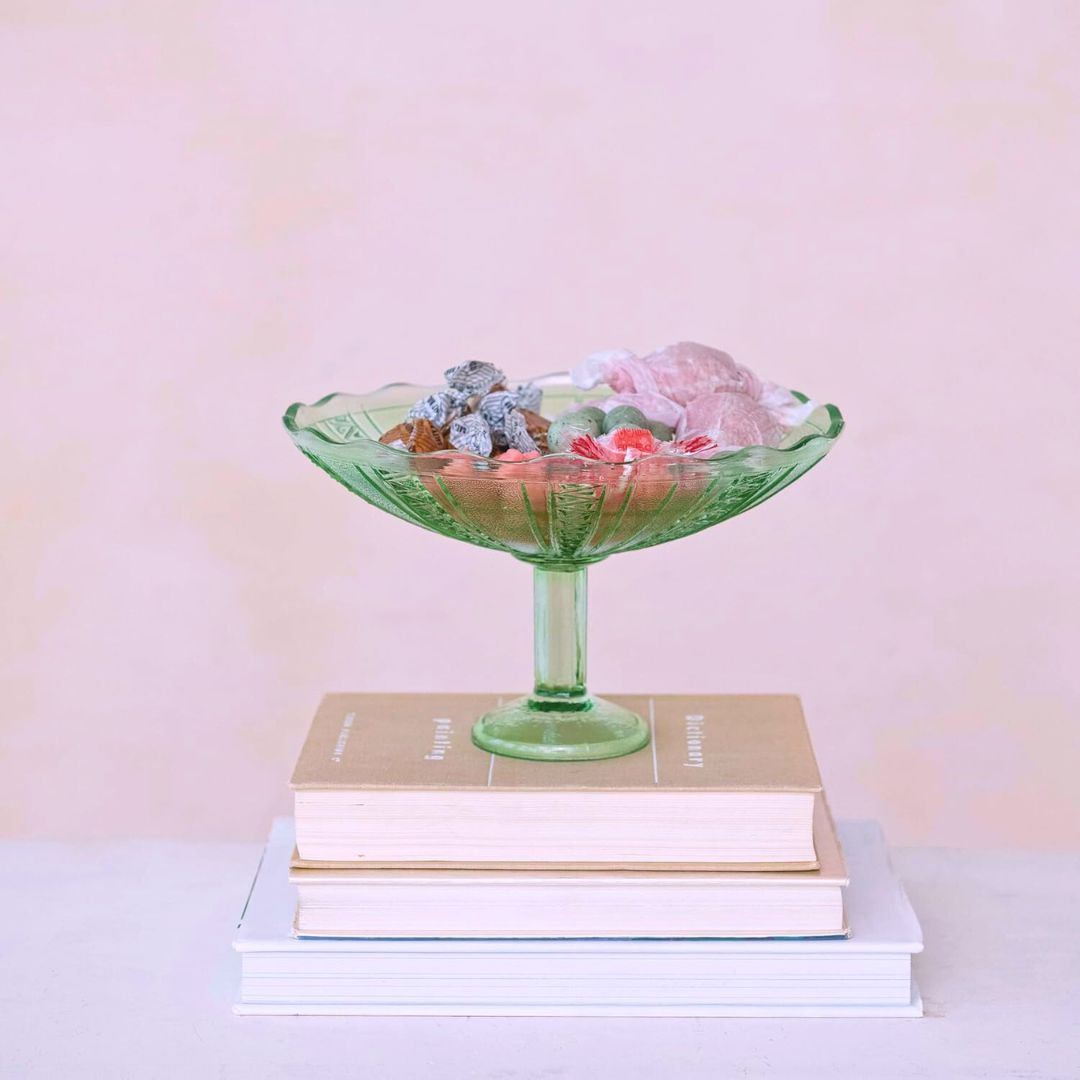 Vintage green glass bowl with intricate pressed patterns, ideal for serving or as a decorative accent, adding a touch of elegance and color to any table.