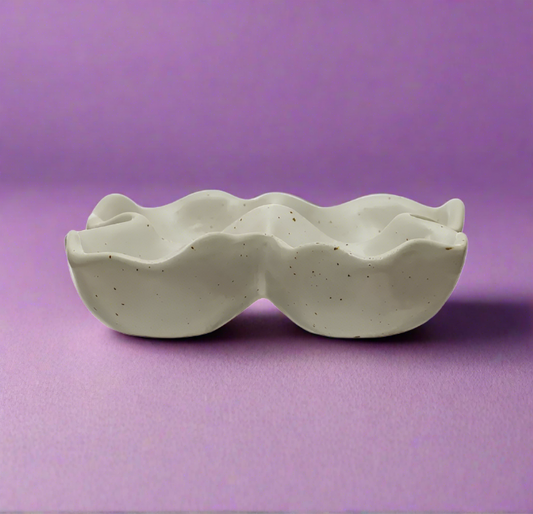 White Stoneware Egg Holder with Reactive Glaze, holding up to 4 eggs. Features a unique glaze finish that adds coastal charm and practical style to your kitchen decor.

