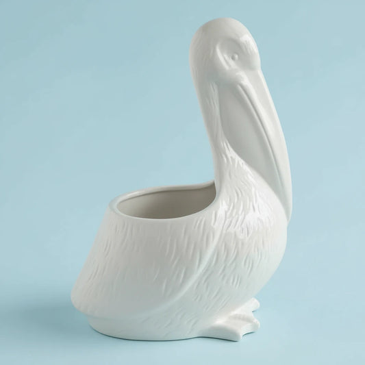 White ceramic pelican-shaped planter holding a 5-inch plant pot, displayed as decorative home décor.