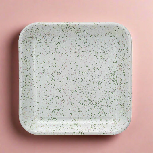 Enameled metal splatterware serving platter with bold, playful paint design.
