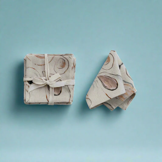  Set of four 10-inch square cotton and linen cocktail napkins with oyster pattern.