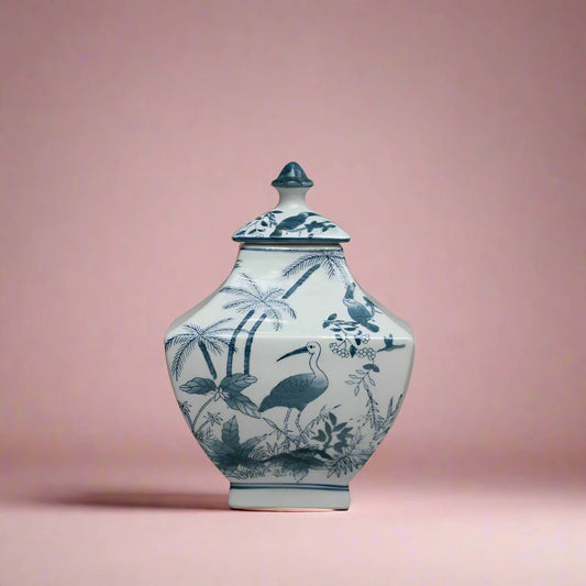 Hand-painted blue and white porcelain ginger jar with bird motifs and crackle glaze finish.
