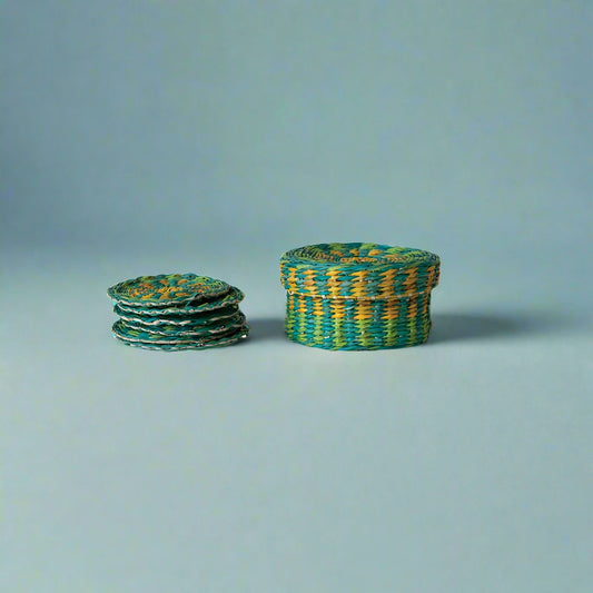 Set of six hand-woven seagrass coasters with matching holder and lid, styled on a table.
