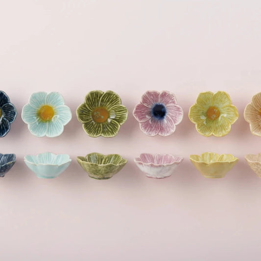 Set of small ceramic bowls with floral designs on a white background