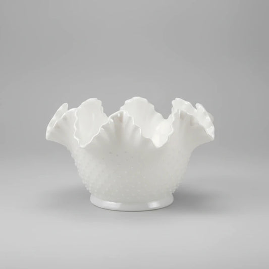 White ceramic bowl with textured surface on a white background