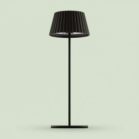 Black floor lamp with pleated shade on a white background