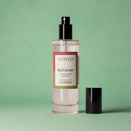 Room and linen spray bottle styled on soft fabrics, ready to refresh any space.
