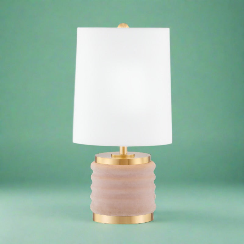 Blush Velvet Charm Table Lamp with a chic blush velvet shade and gold base. Adds a touch of cozy sophistication and color to any room